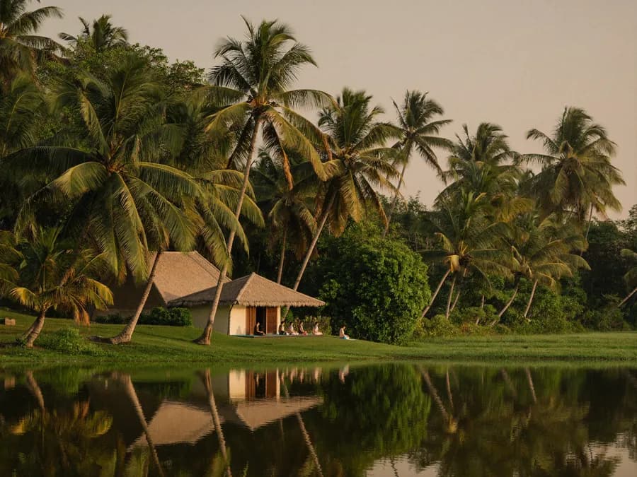 Open-air yoga shala on the Kerala backwaters at golden hour